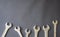 Group of wrenches arranged on dark background