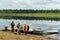 A group of Yakut Asians are waiting at the boats on the Bank