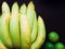 group of yellow banana and green lime ingredient of asia healthcare and energy up food and juice with wood background