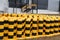 A group of yellow-black road poles on the territory of an industrial enterprise