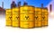Group of yellow drums with radioactive waste in front of nuclear