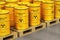 Group of yellow drums with radioactive waste on shipping pallets