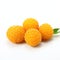 A group of yellow raspberries sitting on top of a white surface