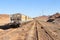 Group of yellow wagons with material for nitrogen fertilizers in desert