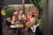 Group of young adult multiethnic friends celebrating new year outdoor, sitting in the backyard, having good time, drinking, wine,
