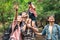 A group of young Asians are planning and looking at maps for camping in the forest.Asian and caucasian are backpackers.Tourism,