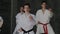 Group of young athletes feet barefoot, white kimono, red and black belts. Pupils training southern and eastern mixed