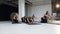 Group of young athletes women making yoga stretching on the floor in fitness class. Concept of yoga, fitness, sport