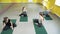 Group of young athletic women doing pilates exercise in studio. Healthy lifestyle concept