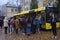 Group of young boys and girls standing in front of the school bus ready to get on. Kyiv, Ukraine