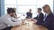 Group of young businessman at the negotiating table in the office. Colleagues look through documents. a business meeting