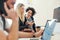 Group of young businesspeople with laptop working together in a modern office.