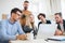 Group of young businesspeople with laptop working together in a modern office.