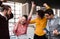 A group of young businesspeople with smartphone standing in office, expressing excitement.