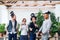 Group of young businesspeople standing in office, party concept.