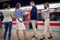 Group of young businesspeople watching at their cell phones, wrist watch, in a subway. time concept