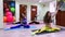 Group of young caucasian women doing stretching sitting on the floor in fitness studio