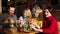 A group of young and cheerful friends eat delicious burgers in a trendy cafe.