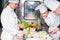 A group of young chefs prepairing meal in luxury restaurant