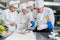 A group of young chefs prepairing meal in luxury restaurant