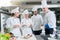 A group of young chefs prepairing meal in luxury restaurant