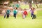 Group Of Young Children Running Towards Camera In Park