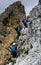 Group of young climbers on a steep vertical Via Ferrata