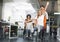 Group of young coworkers enjoying chair race at work