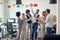 Group of young environmentally focused employees recycling together