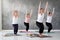 Group of young european woman doung utkatasana or chair pose