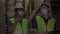Group of young factory warehouse workers wearing a protective face mask while working in logistic industry indoor. Asian