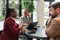 Group of young freelancers real estate agents have business meeting in cafeteria discussing about prices and situation on the rent