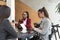 Group of young freelancers real estate agents have business meeting in cafeteria discussing about prices and situation on the rent