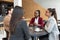 Group of young freelancers real estate agents have business meeting in cafeteria discussing about prices and situation on the rent