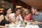 Group Of Young Friends Enjoying Meal In Restaurant