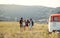 A group of young friends on a roadtrip through countryside, walking.