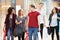 Group Of Young Friends Shopping In Mall Together