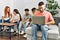 Group of young friends speaking sitting on the sofa