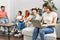 Group of young friends speaking sitting on the sofa