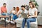 Group of young friends speaking sitting on the sofa