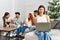 Group of young friends speaking sitting on the sofa