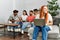 Group of young friends speaking sitting on the sofa