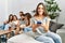 Group of young friends speaking and sitting on the sofa at home