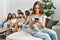 Group of young friends speaking and sitting on the sofa at home