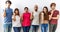 Group of young friends standing together over isolated background surprised pointing with hand finger to the side, open mouth