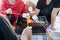 Group Of Young Friends Toasting Marshmallows Around Fire On the beach. Active Teenagers outdoor activity. Close up