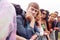 Group Of Young Friends Waiting Behind Barrier At Entrance To Music Festival Site