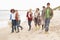 Group Of Young Friends Walking Along Autumn Shorel