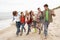 Group Of Young Friends Walking Shoreline