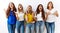 Group of young girl friends standing together over isolated background crazy and mad shouting and yelling with aggressive